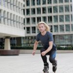 Young man roller skating through urban landscape, enjoying a dynamic outdoor lifestyle.