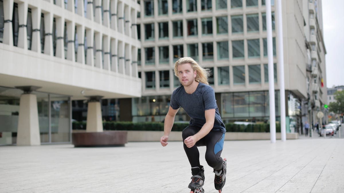Young man roller skating through urban landscape, enjoying a dynamic outdoor lifestyle.